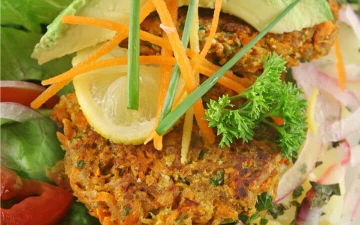 Overhead image of Tuna patties over a simple salad with avocado