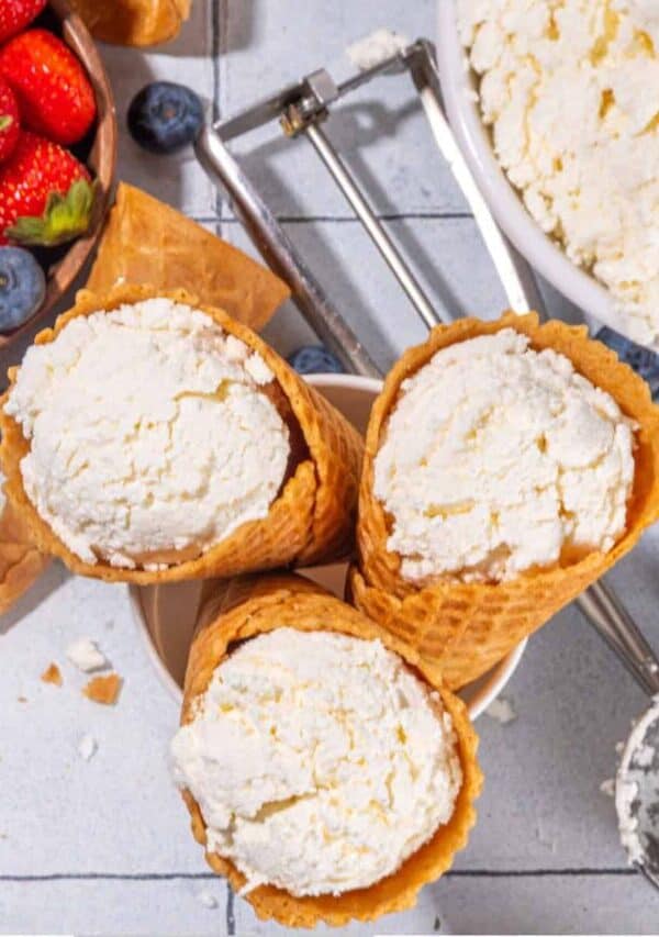 Overhead image of three Cottage Cheese Ice Cream Cones with a bowl of fruit