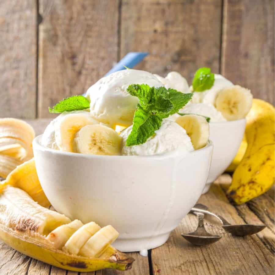 Two Bowls of Banana Ice Cream with garnish of fresh bananas and mint
