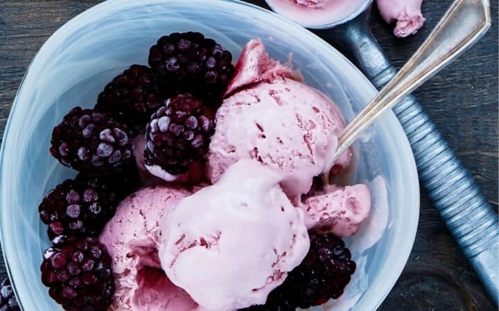 Overhead image of Blackberry Ice Cream in a blue bowl with extra berries