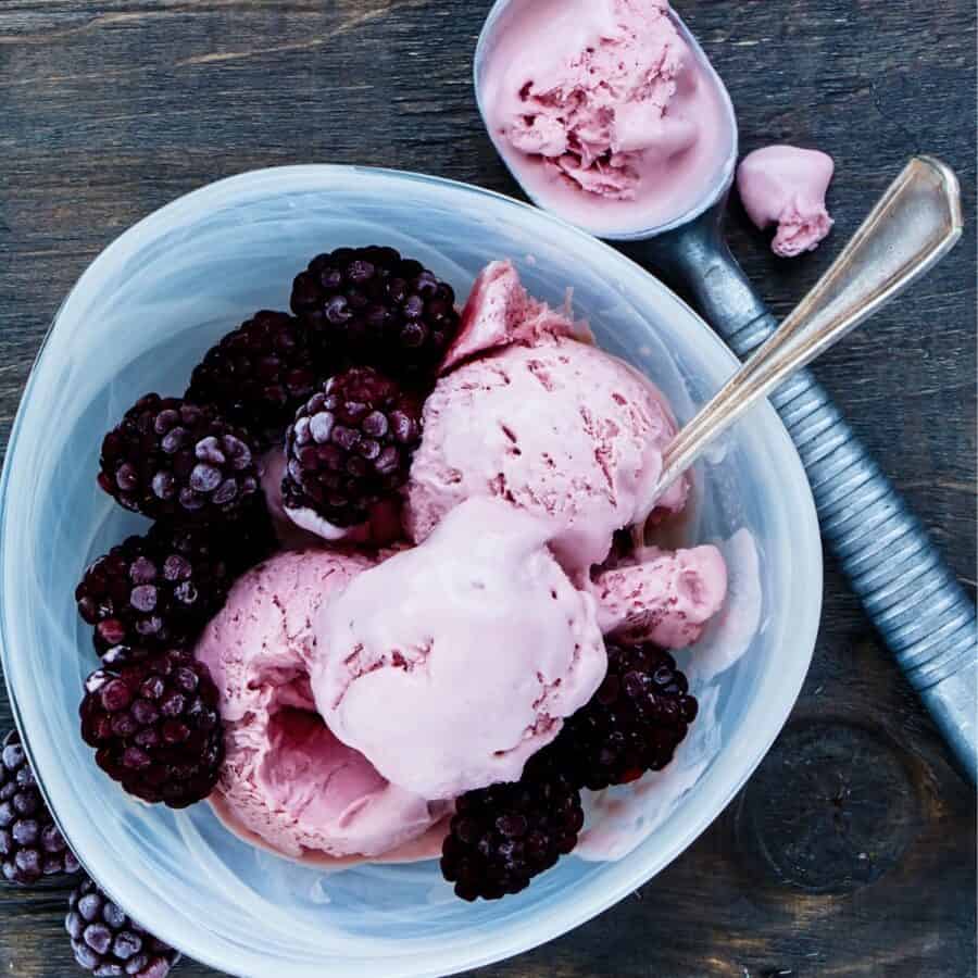 Overhead image of Blackberry Ice Cream in a blue bowl with extra berries