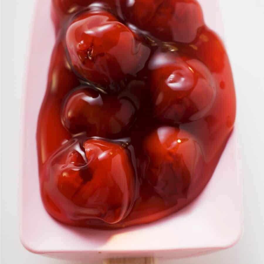 Close up image of Cherry Pie Filling on a pink silicone spatula