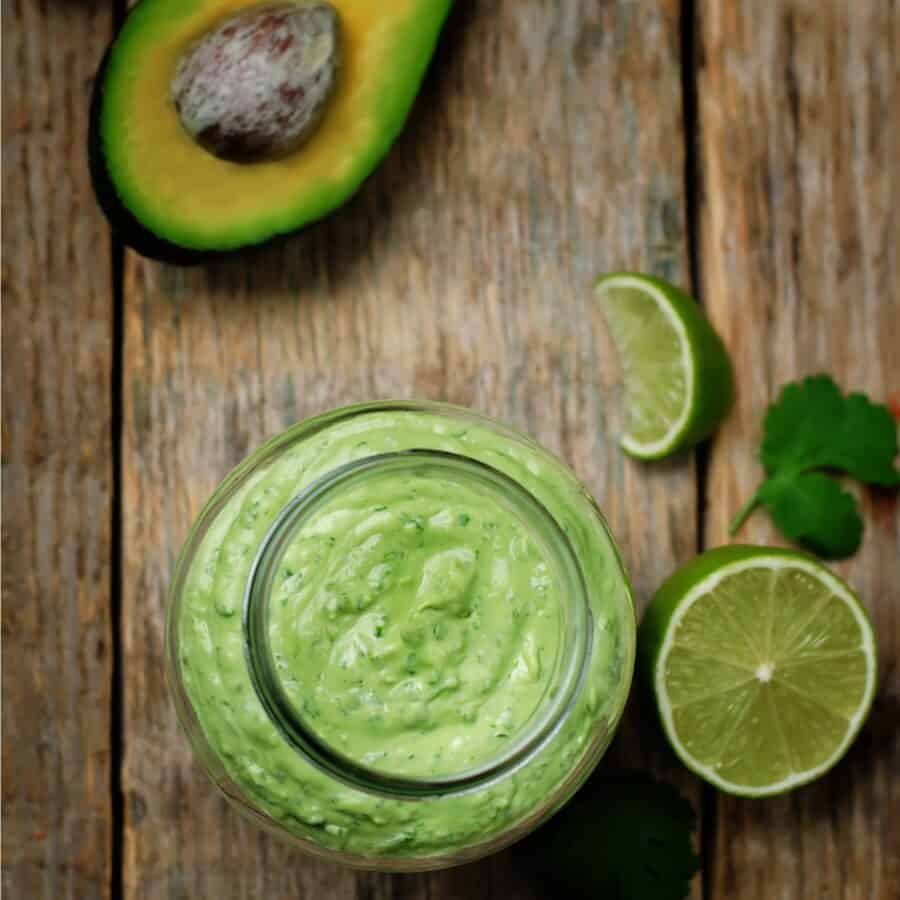Overhead image of Cilantro Lime Dressing in a glass jar with prepped produce
