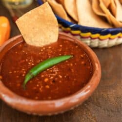 Salsa Roja in a bowl with chips in the background