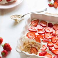 Close up image of Strawberry Tiramisu in a baking dish with a portion missing