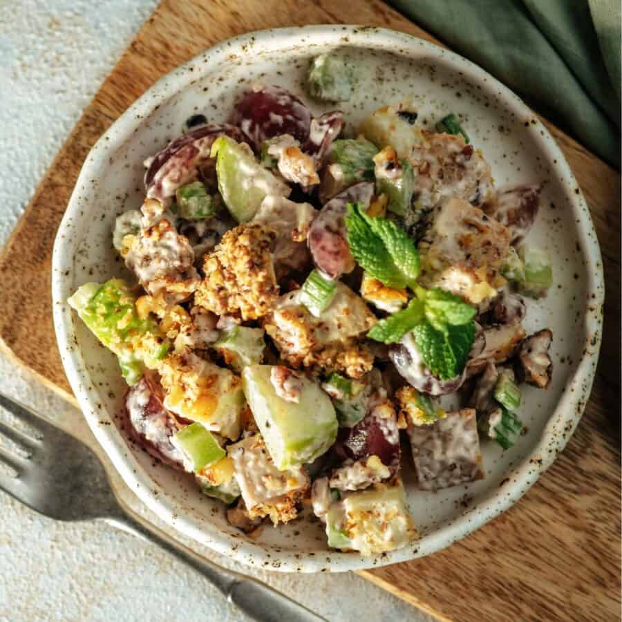 Overhead image of Waldorf Salad in a gray bowl on a cutting board