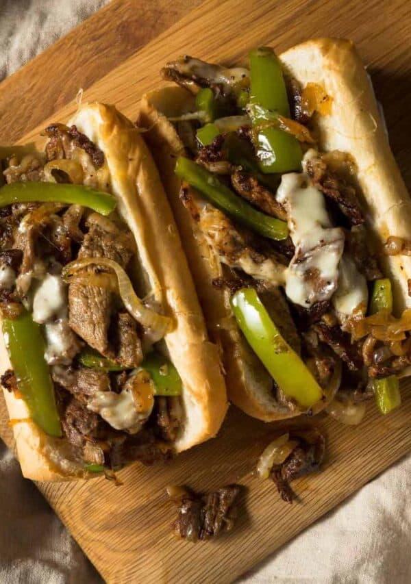 Overhead image of two Blackstone Philly Cheesesteaks on a wooden cutting board
