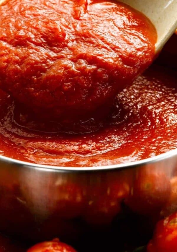 Homemade Pizza Sauce in a bowl being served with a spoon