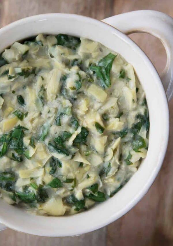 Overhead image of Vegan Spinach Artichoke Dip in a white crock