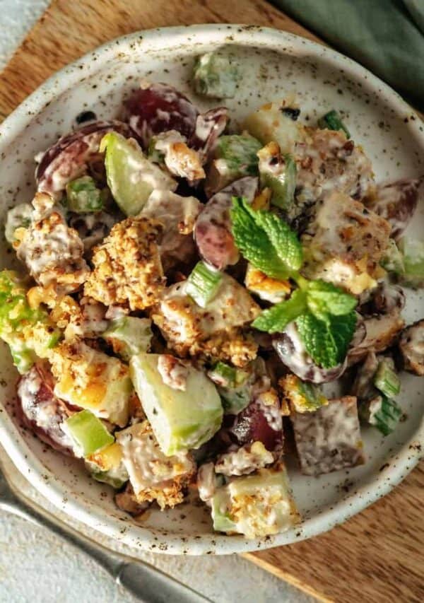 Overhead image of Waldorf Salad in a gray bowl on a cutting board