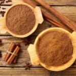 Overhead image of Apple Pie Spice in two bowls with cinnamon sticks next to them - 8