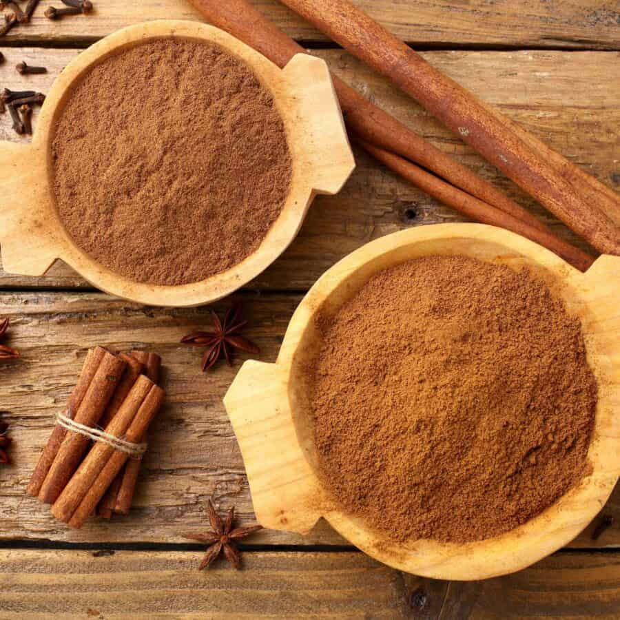 Overhead image of Apple Pie Spice in two bowls with cinnamon sticks next to them