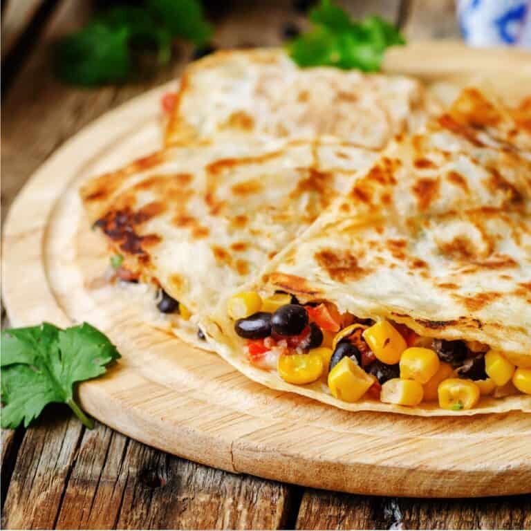 Black Bean Quesadilla cut into pieces on a round cutting board