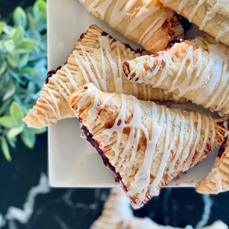 Cherry Turnovers stacked on a white platter