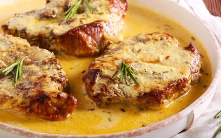 Creamy Pork Chops on a round white plate
