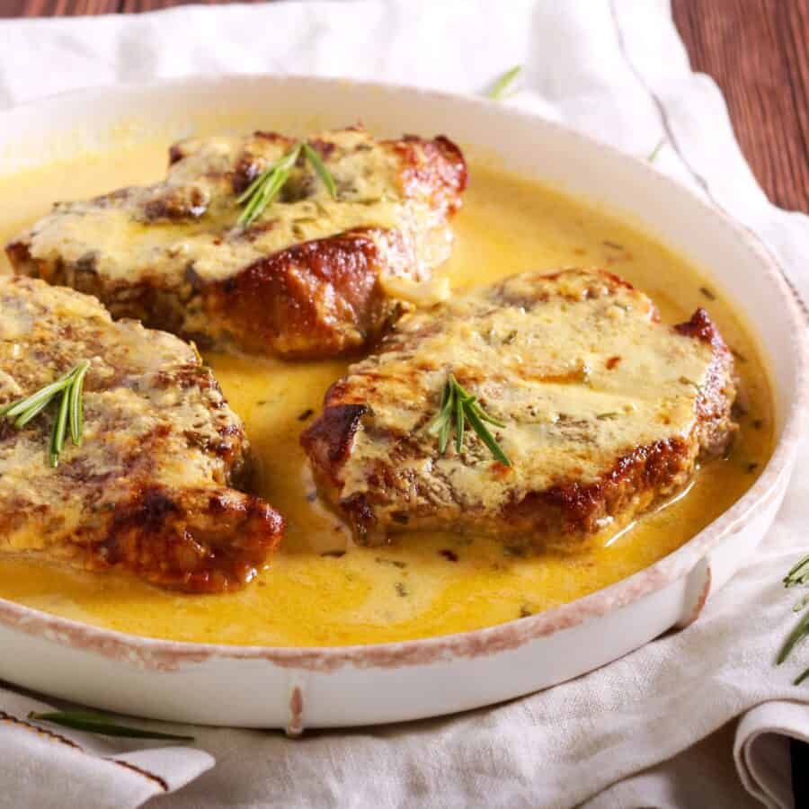 Creamy Pork Chops on a round white plate
