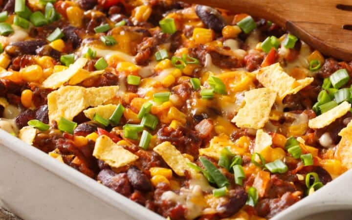 Close up image of Frito Pie in a white casserole dish