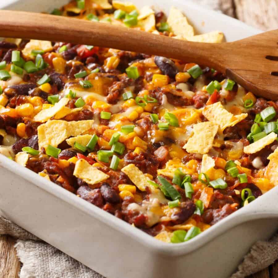 Close up image of Frito Pie in a white casserole dish