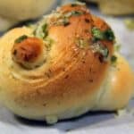 Close up image of Garlic Knots on parchment paper - 8