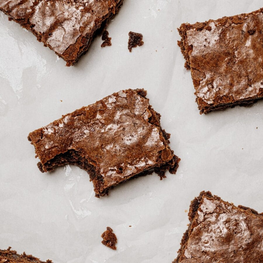 Overhead image of Lunch Lady Brownies cut into pieces on parchment paper