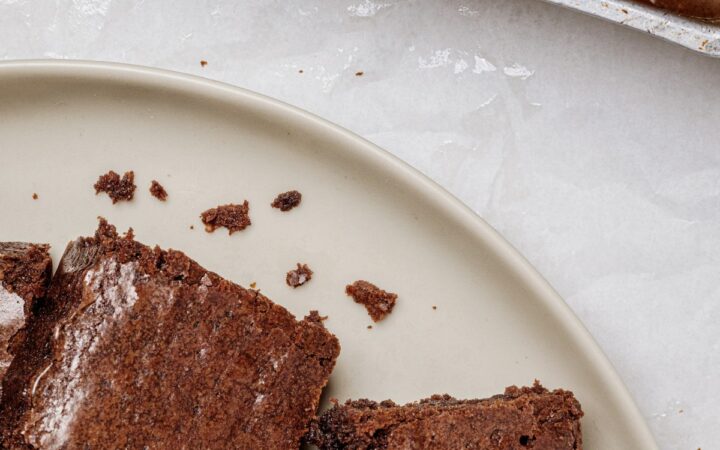 Lunch Lady Brownies on a plate next to an uncut pan of them
