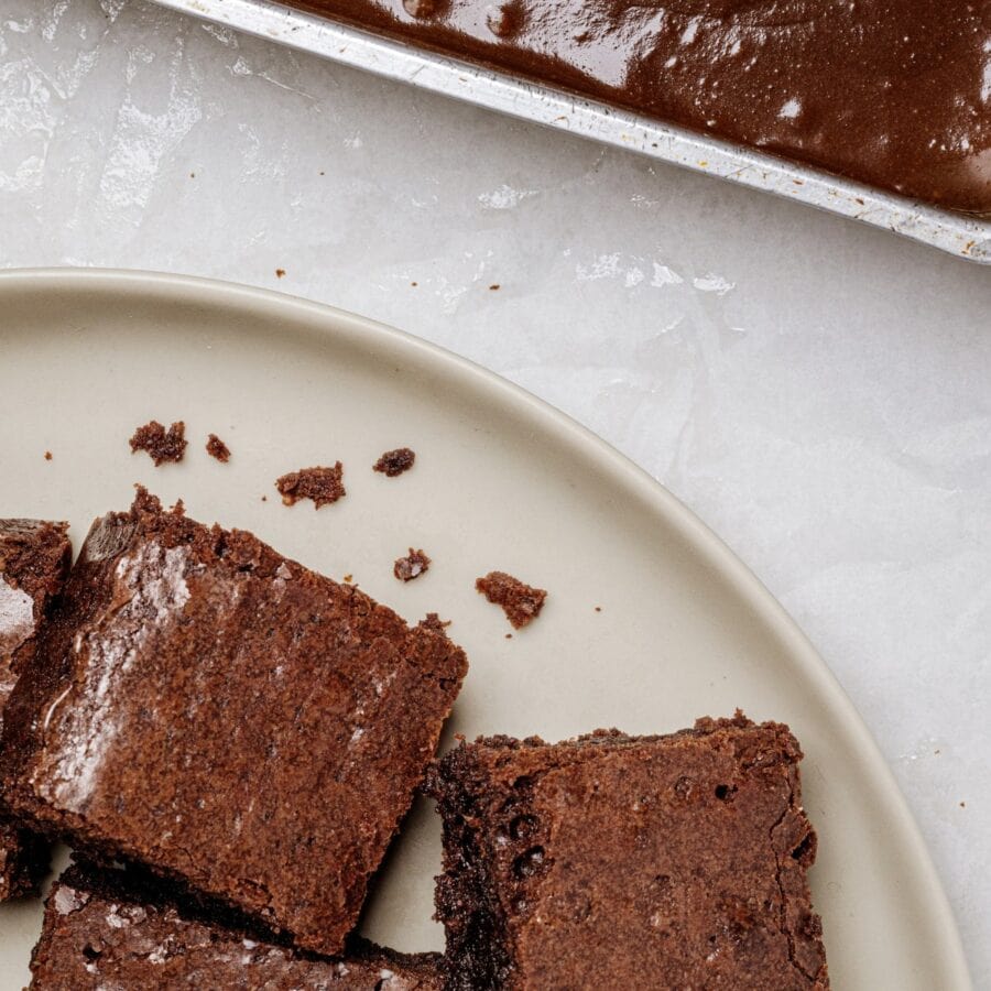 Lunch Lady Brownies on a plate next to an uncut pan of them
