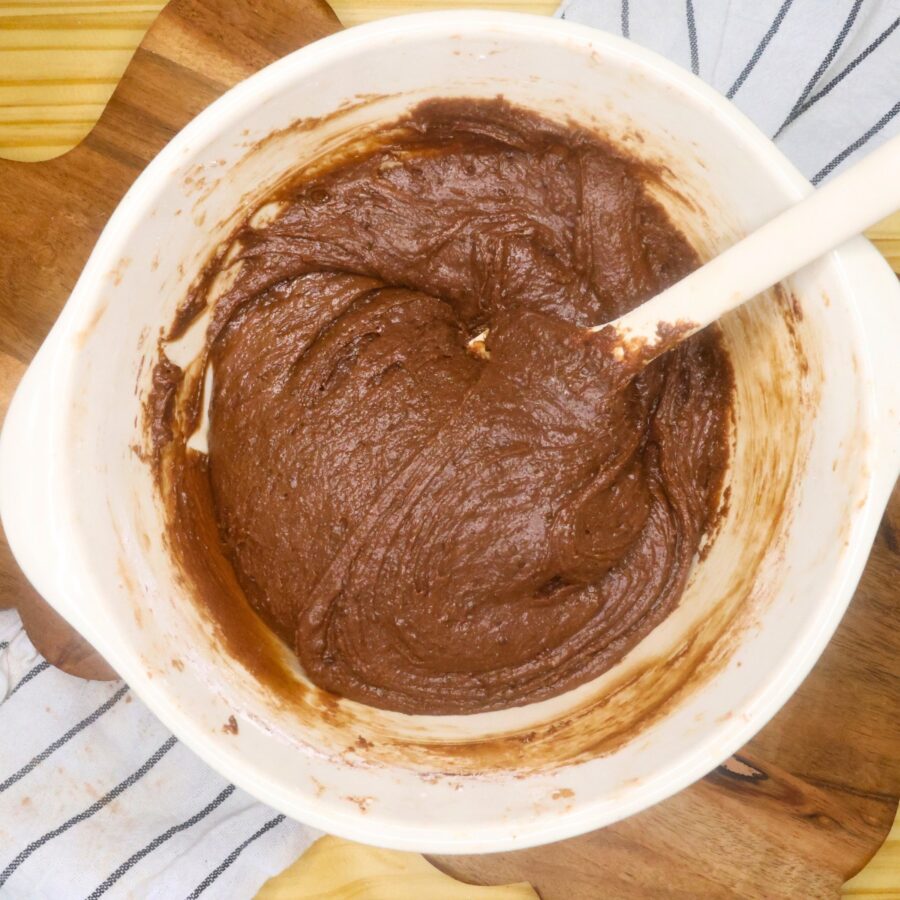 Batter for Lunch Lady Brownies in a mixing bowl with a silicone spatula