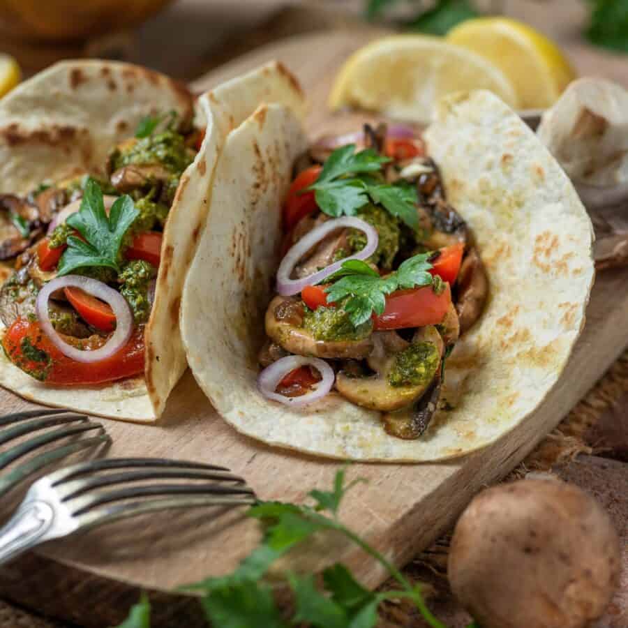 Two mushroom tacos on a rustic background