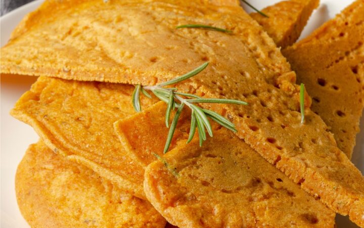 Close up image of socca with herbs