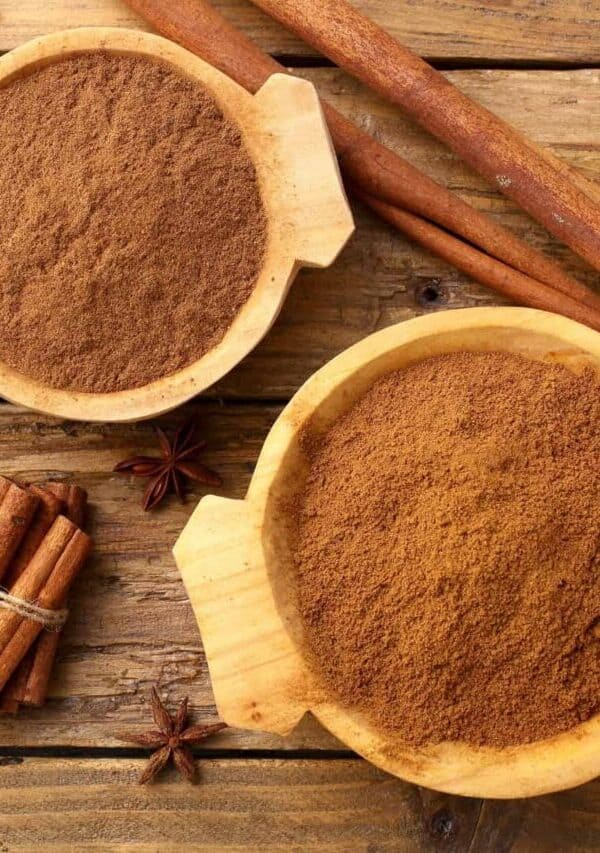Overhead image of Apple Pie Spice in two bowls with cinnamon sticks next to them