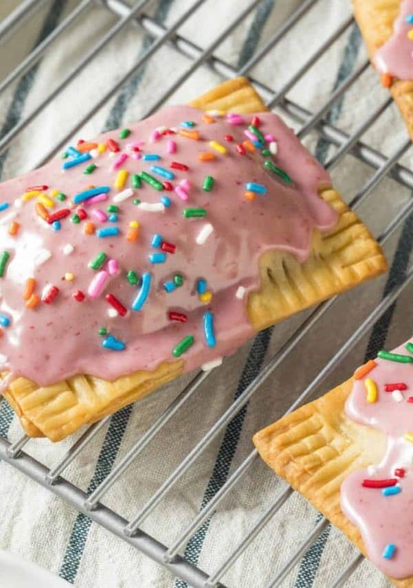 Close up image of Homemade Poptarts with pink frosting and sprinkles on a cooling rack