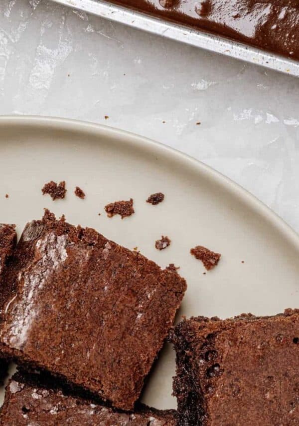 Lunch Lady Brownies on a plate next to an uncut pan of them