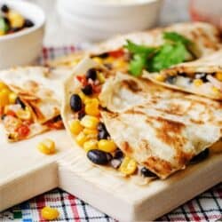 Close up image of a Black Bean Quesadilla on a wooden cutting board