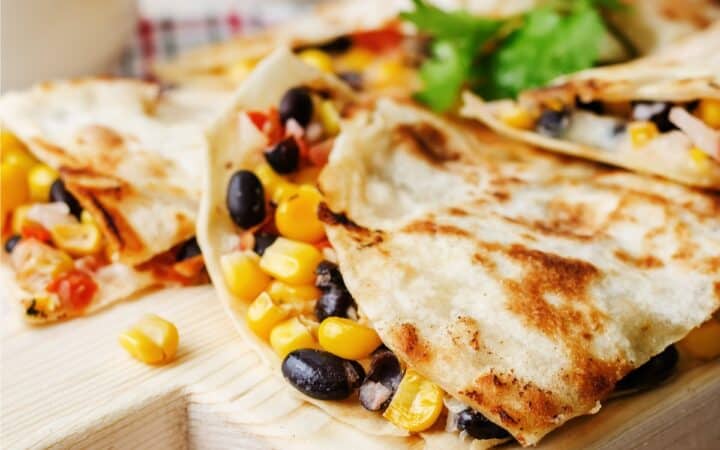 Close up image of a Black Bean Quesadilla on a wooden cutting board