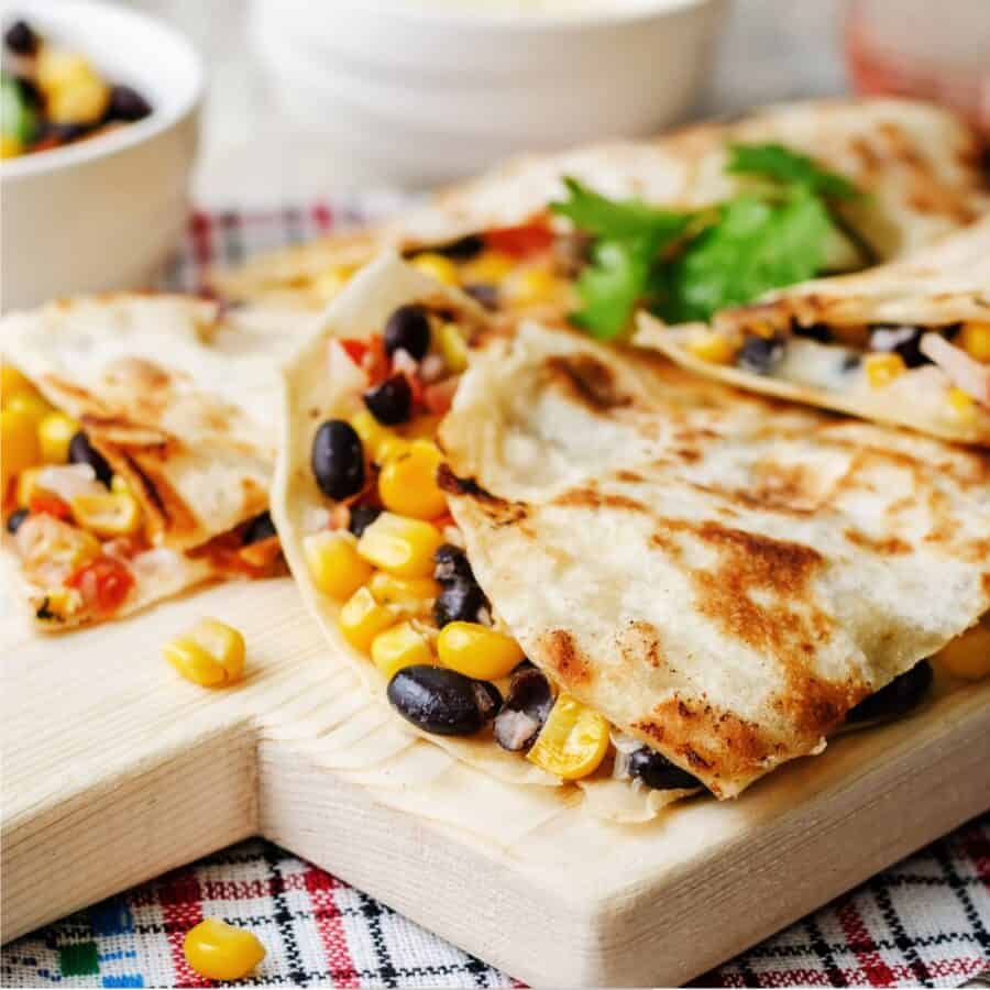 Close up image of a Black Bean Quesadilla on a wooden cutting board