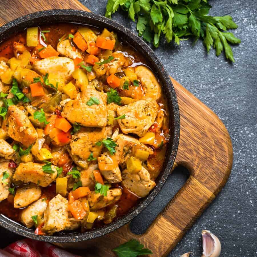 Overhead image of Slow Cooker Chicken Stew in a pan on top of a cutting board