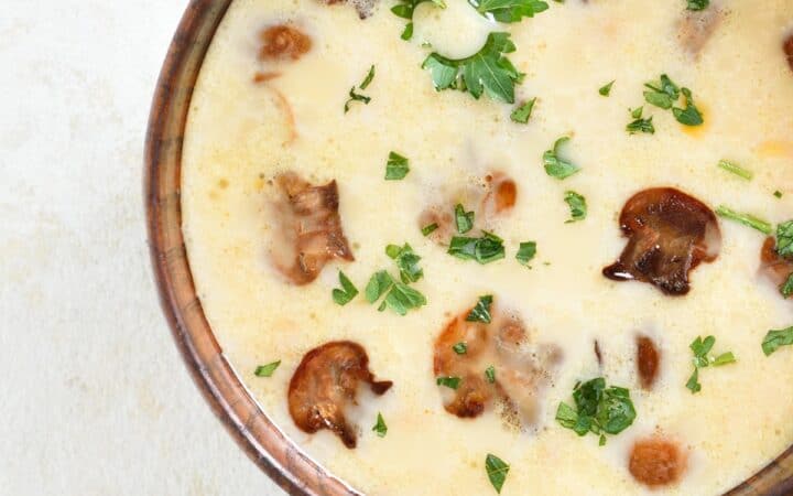 Close up image of Creamy Mushroom Soup in a brown bowl