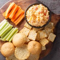 Overhead image of Pimento Cheese Dip on a board with dippers