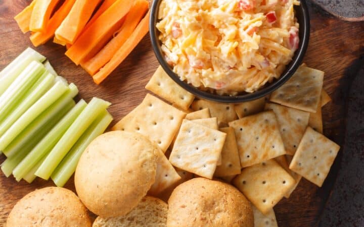 Overhead image of Pimento Cheese Dip on a board with dippers