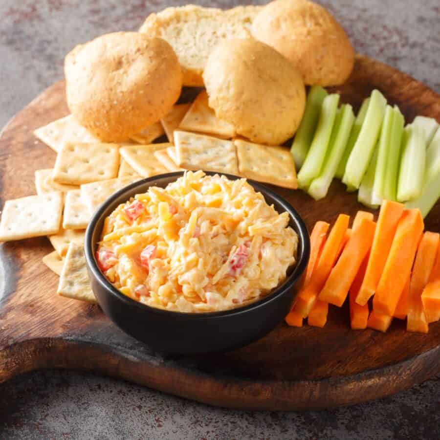 Pimento Cheese Dip in a black bowl on a charcuterie board