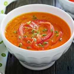 Close up image of Roasted Red Pepper Soup in a white bowl