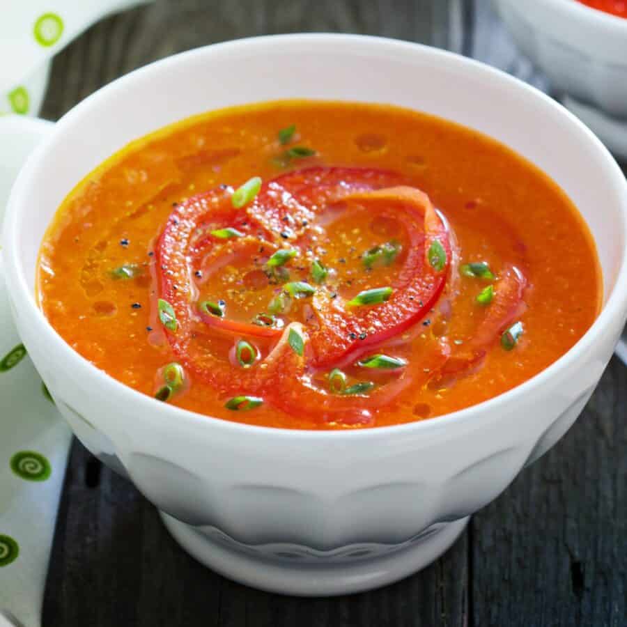 Close up image of Roasted Red Pepper Soup in a white bowl