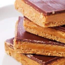 Four Twix Bars stacked on a top of eachother on a plate