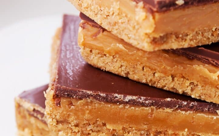 Four Twix Bars stacked on a top of eachother on a plate