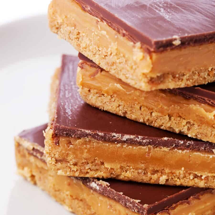 Four Twix Bars stacked on a top of eachother on a plate
