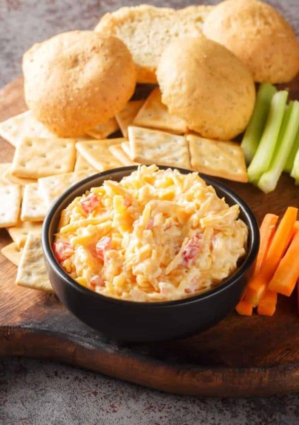 Pimento Cheese Dip in a black bowl on a charcuterie board