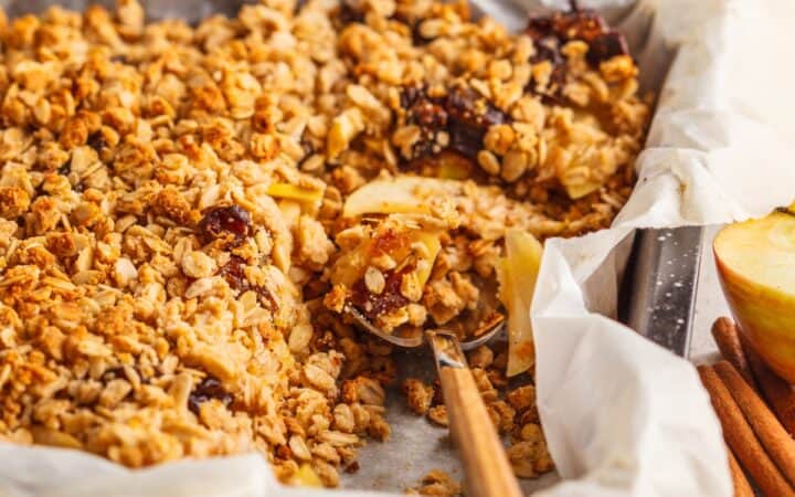 Baked Apple Cinnamon Oatmeal with a serving spoon
