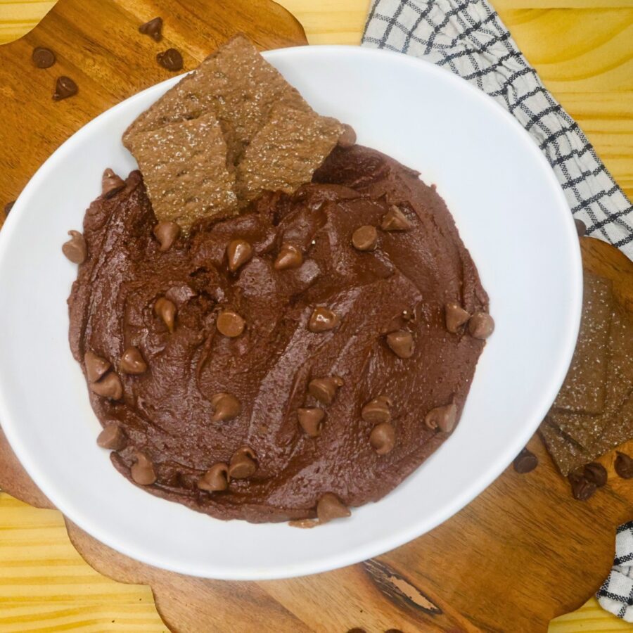Overhead image of brownie batter dip in a white bowl with chocolate graham crakcer dippers