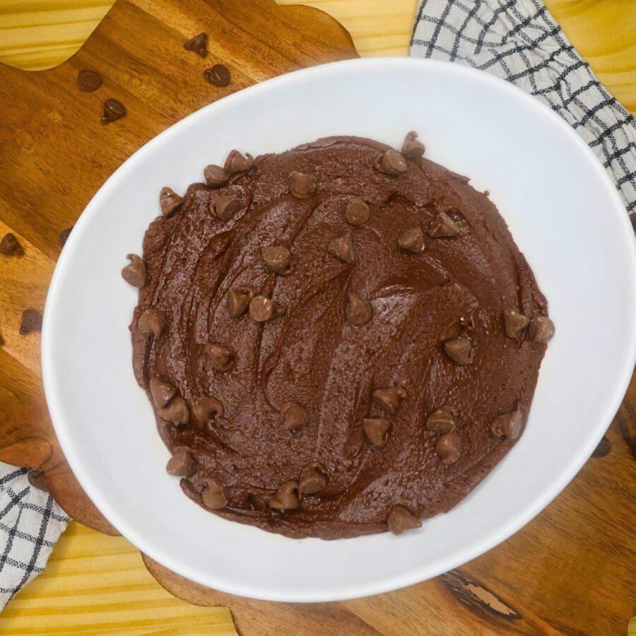 Brownie Batter Dip garnished with chocolate chips in a white bowl