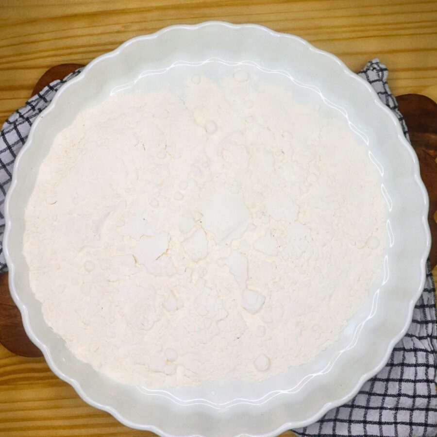 Overhead image of heat treated flour in a white baking dish
